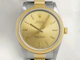 a watch that has a gold dial on it