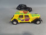 two toy cars that are sitting next to each other on a table