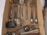 a box full of silverware and a knife and spoons