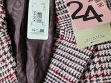 a label on a coat that says 24 on it