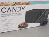 packaging of a microwave with a box of candy inside of it