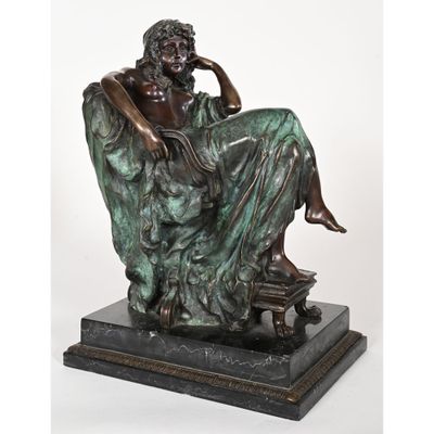 bronze statue of a man sitting on a bench with his hand resting on his chin