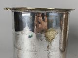 a silver cup with a picture of a man on it