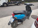 a scooter that is parked on the side of the street