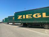 a lot of trucks that are parked on the side of the road