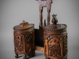 pair of carved wooden boxes and a wooden chair on a gray background