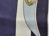 a close up of a tie with a blue and white striped background