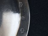 a close up of a silver knife on a black cloth