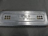 an old silver harmonica that is sitting on a table
