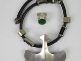 silver and green necklace with a leather cord and a silver pendant with a green stone on it