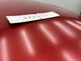 a sticker sitting on the hood of a red car