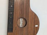 a wooden instrument that is hanging on the wall