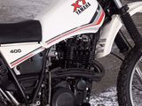 a white motorcycle parked in a garage with snow on the ground