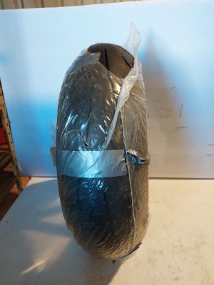 a large black object wrapped in plastic sitting on a table