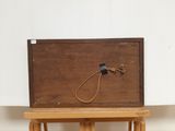 a small wooden box with a rope on top of it
