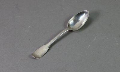 a silver spoon with a spoon handle on a table
