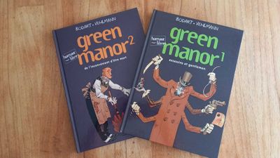 two books that are sitting on a wooden table