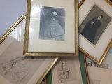 a lot of framed pictures on the wall of this room