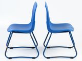 pair of blue plastic school chairs against a white background