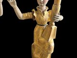 statue of a woman holding a baseball bat in her right hand