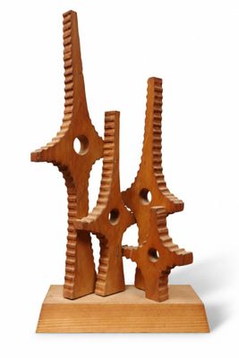 a wooden sculpture that is sitting on a wooden stand