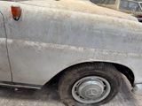 a dirty car that is parked in a garage