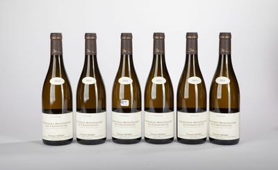 six bottles of wine lined up in a row on a table