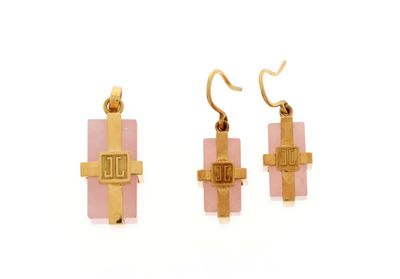 two pieces of gold and pink glass with a cross on them