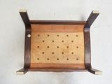 an overhead view of a wooden tray with holes in it