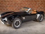 an image of a black sports car parked in front of a brick wall