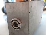 a metal box with a hole in it on a table