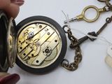a close up of a person holding a pocket watch