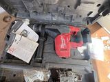 a red tool sitting on top of a piece of metal