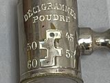 a silver cup that has a handle on it