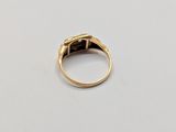 a close up of a gold ring on a white surface