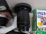 a camera that is sitting on a table next to a book and a camera