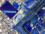 a close up view of a blue and white mosaic tile