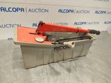 an orange and black pipe cutter sitting on top of a metal container