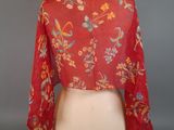 an image of a woman ' s red floral blouse on a mannequin dummy