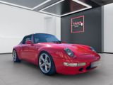 red sports car parked in a showroom with a black and white wall
