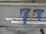 two clamps that are attached to a piece of wood