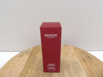 the red box is sitting on a wooden table next to a white wall