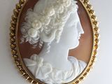 a close up of a picture of a woman ' s face in a gold frame