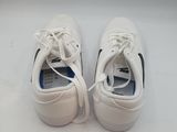 pair of white tennis shoes sitting on a white surface