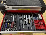 someone is holding a tool box with tools in it