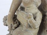 a statue of a woman holding a child on a rock