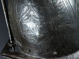 a close up of a person holding a silver helmet