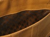 the inside of a brown purse with a leopard print lining