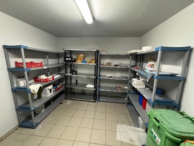 a room that has shelves and bins in it