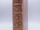 an old book sitting on top of a table next to a white background